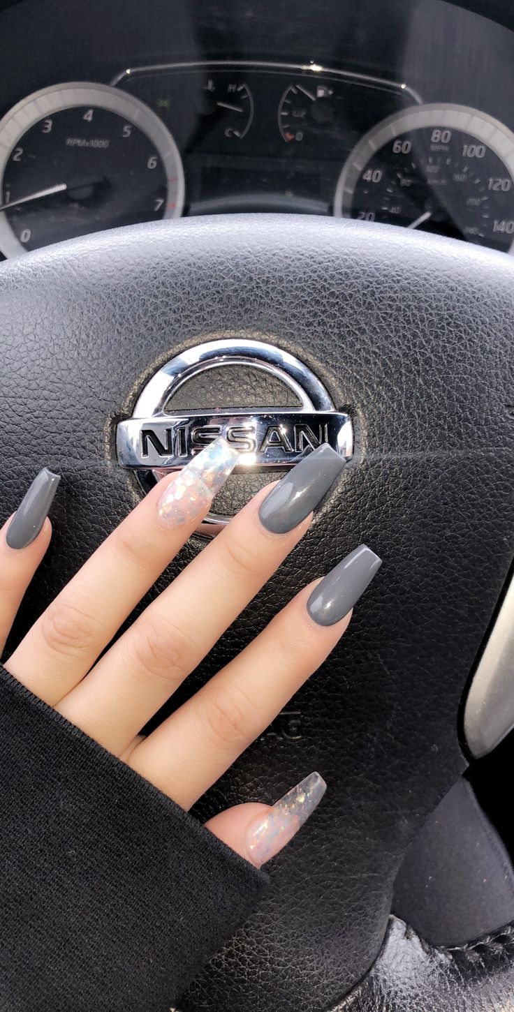 Chic Almond-Shaped Nail Design: Matte Gray Meets Glittery Accents for Elegant Sophistication.