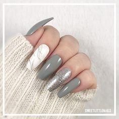 Chic Gray and White Nail Design with Marble Accent and Glitter Sparkle.