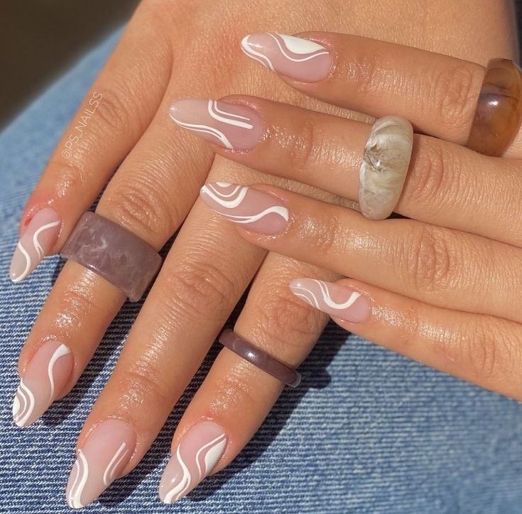 Chic Nude and White Marbled Nail Design with Stylish Ring Accents.