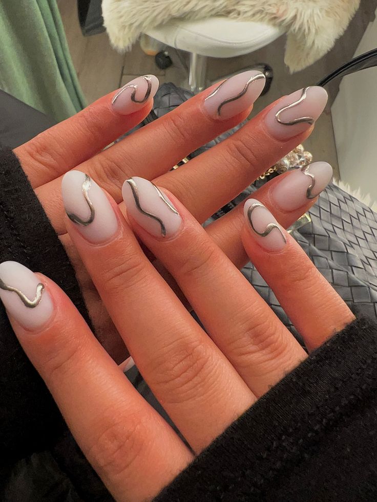 Sophisticated Matte Pastel Nail Design with Wavy Metallic Lines for Artistic Elegance.