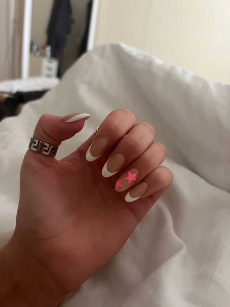 Stylish Chic French Tip Nails with Playful Pink Star Accent.