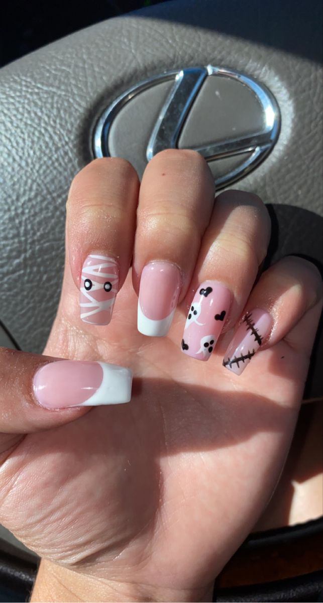 Elegant Halloween Nail Design with Pastel Pink Mummy, Ghosts, and Stitched Accents