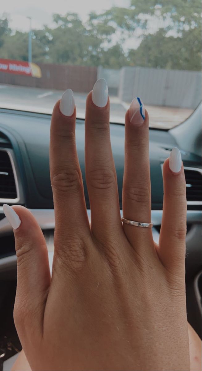 Sophisticated Almond-Shaped White Nails with a Blue Accent for a Modern Minimalist Look.