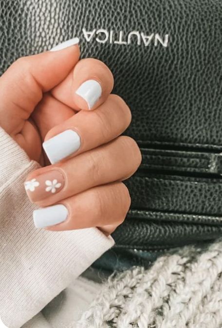 Pastel Blue Nail Design with Minimalist Floral Accents for a Trendy Spring Look.