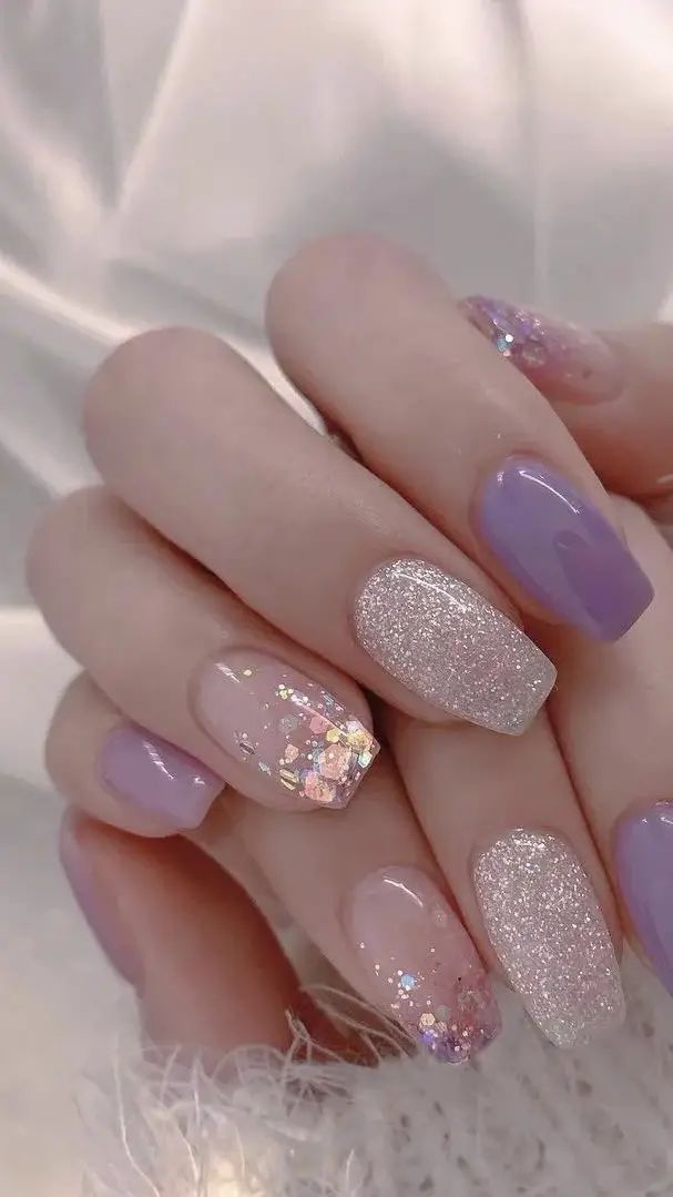 Elegant Pastel Nail Design with Glitter Accents and Stylish Finish.