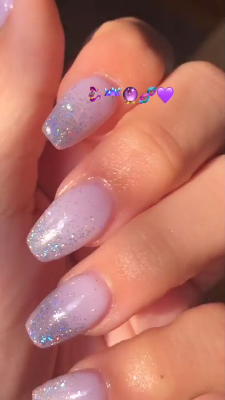 Elegant Lavender Gradient Nails with Sparkling Glitter Tips and Iridescent Accents.