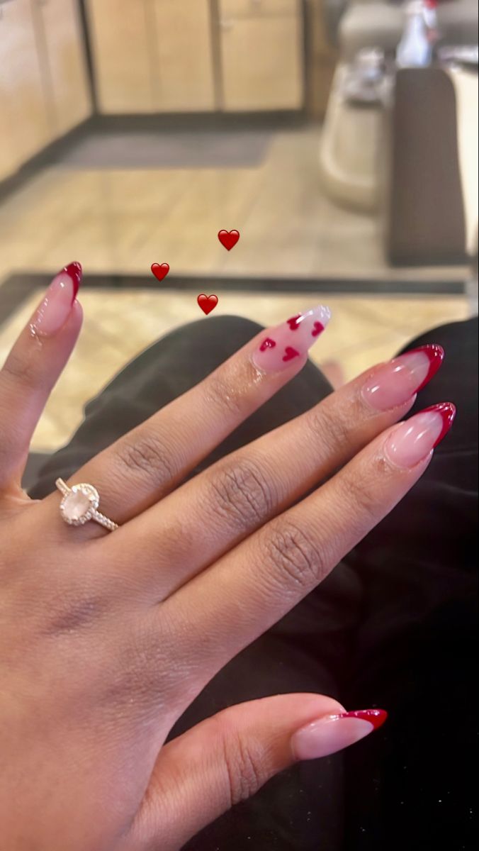 Romantic Pink and Red Nail Design with Heart Patterns and Glitter Accents.