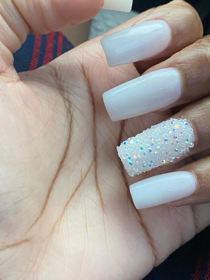 Chic Long White Nails with Dazzling Multi-Colored Glitter Accent.