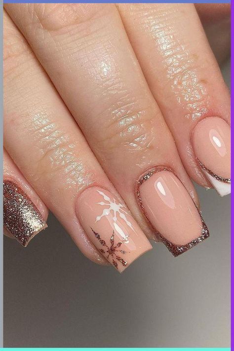 Chic Winter Nail Design: Nude and Metallic Elegance with Glitter Tips and Snowflake Accents.