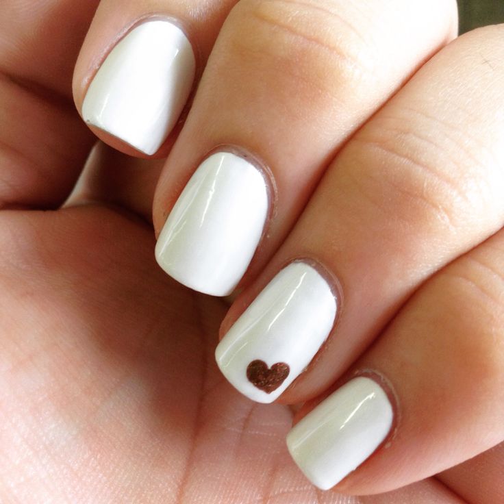 Elegant Chic White Manicure with Playful Heart Accent.