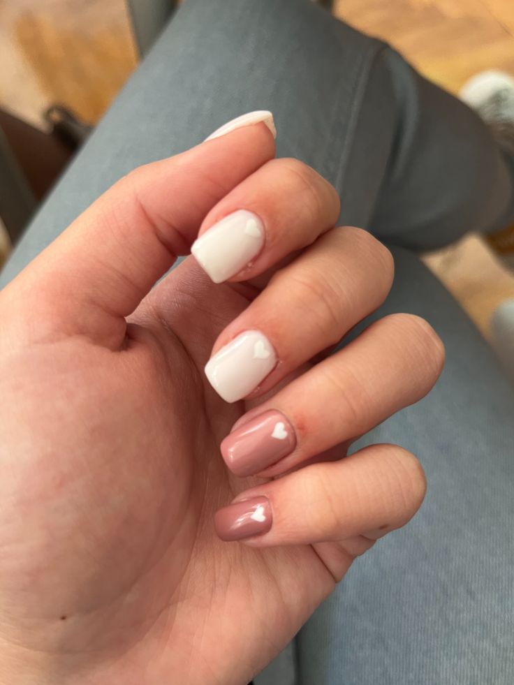 Chic Nail Design: Soft White and Muted Pink with Heart Accent