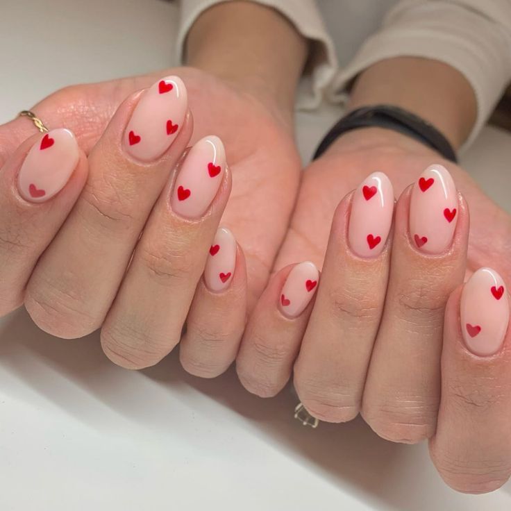 Charming Red Hearts on Soft Nude Nails: A Playful and Romantic Design.