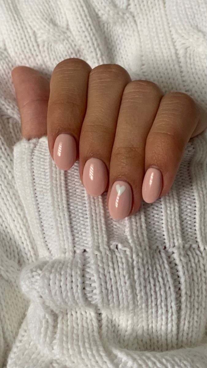 Chic Soft Pink Nail Design with Heart Accent for a Cozy Style