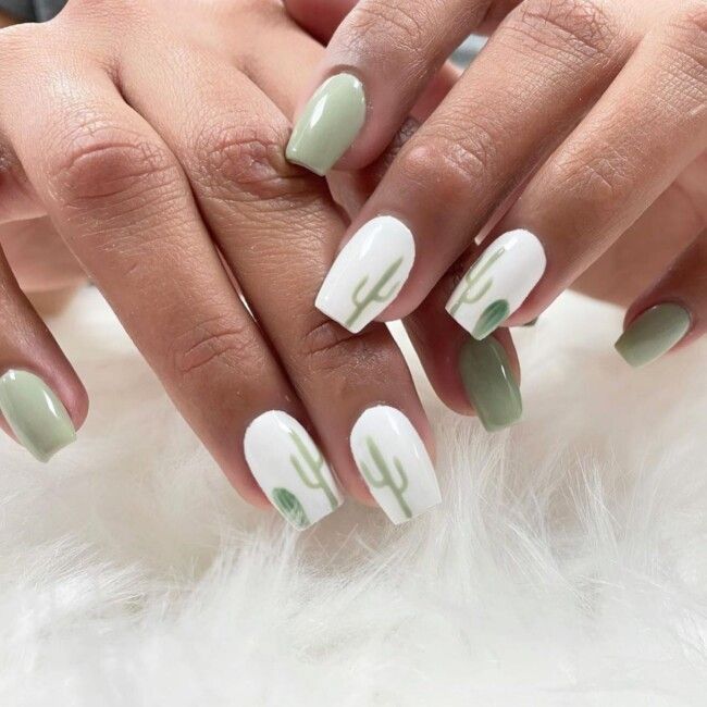 Trendy Cactus-Inspired Nail Design with Soft Green and Crisp White Tones.