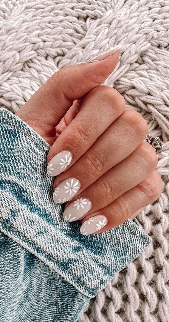 Elegant Floral Nail Design in Soft Beige and White Accents for Spring/Summer.