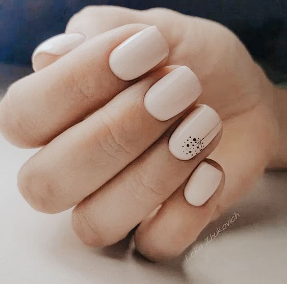 Sophisticated Beige Nail Design with Minimalist Black Accents for Any Occasion.