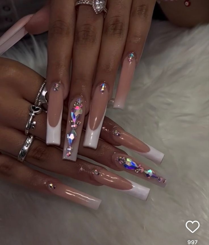 Glamorous Soft Pink and White French Manicure with Sparkling Rhinestones and Colorful Gems.