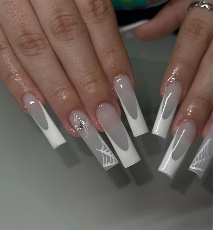 Chic Long Acrylic Nails with Sheer Nude and Glossy White, Adorned with Spiderweb Patterns and Glamorous Charm.