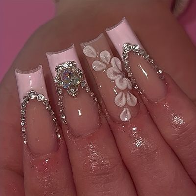 Sophisticated Glamour: Elegant Long Pink Nail Design with Rhinestones and Floral Accents.