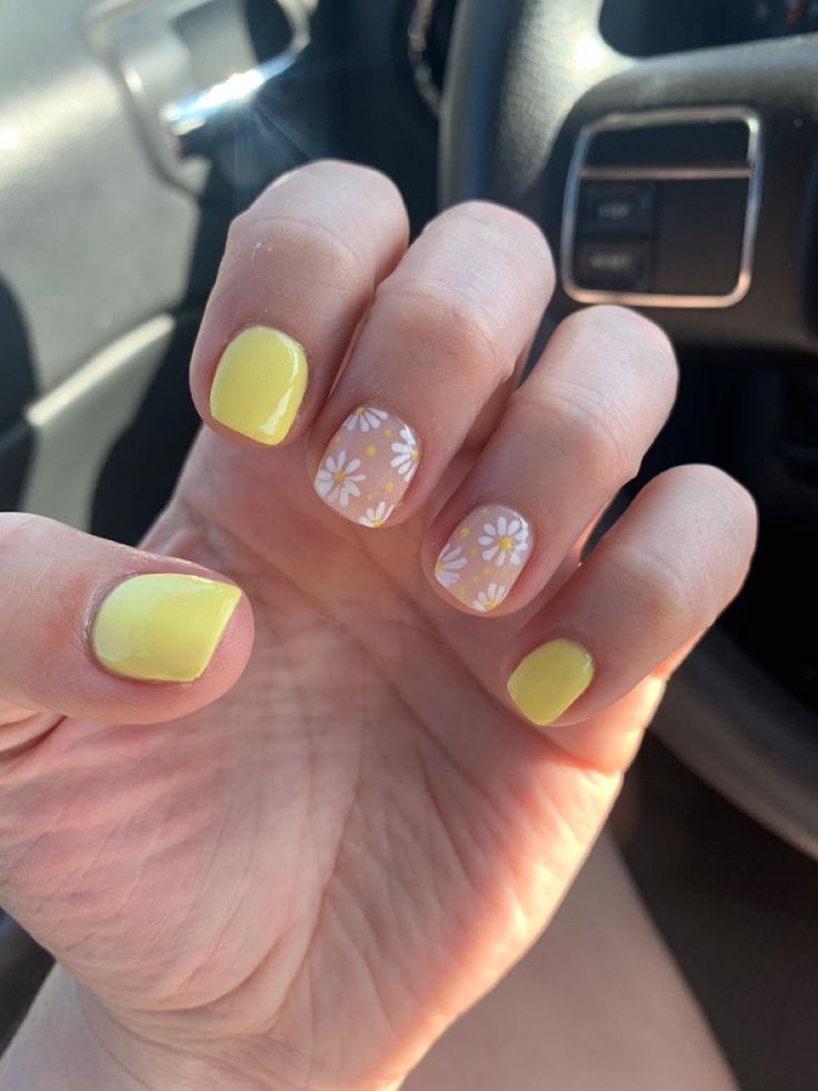 Playful Vibrant Yellow Nail Design with Floral Accent for a Summery Vibe.