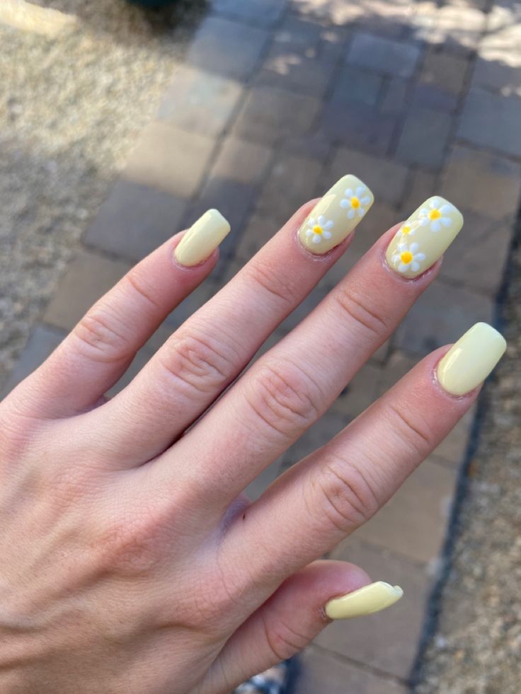 Charming Floral Yellow Nail Design with Pastel Accents and Modern Square Shape.