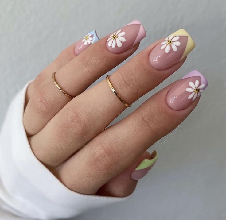 Playful Pastel Floral Nail Design with Geometric Shapes and Whimsical Daisy Accents.