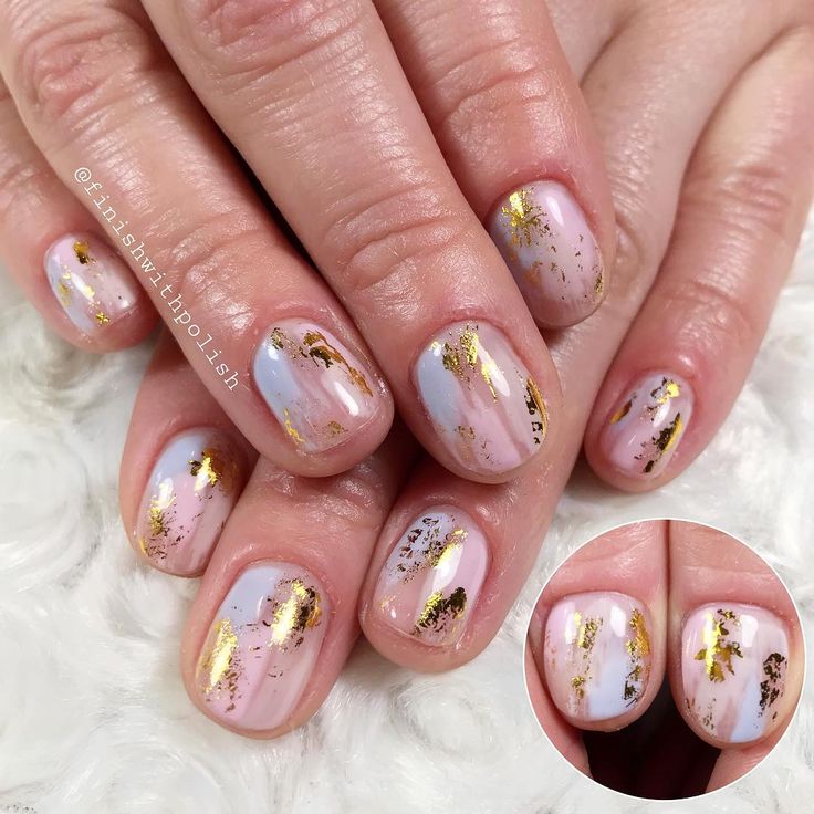 Sophisticated Pastel Nail Design with Light Blue and Gold Leaf Accents.