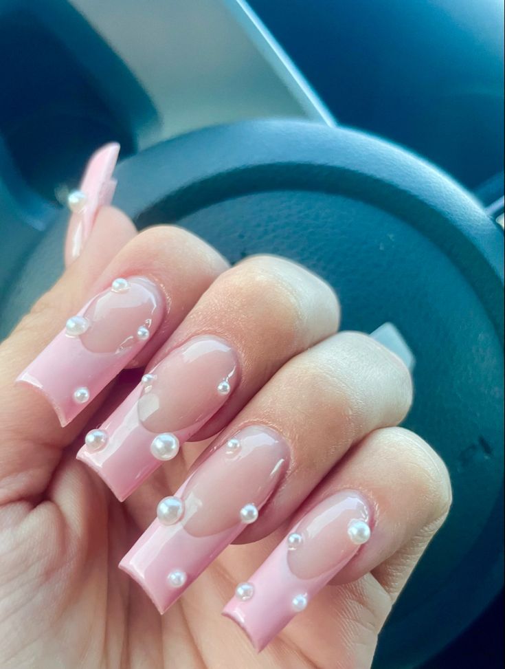 Sophisticated Soft Pink Nail Design with Glossy Accents and Pearl Embellishments