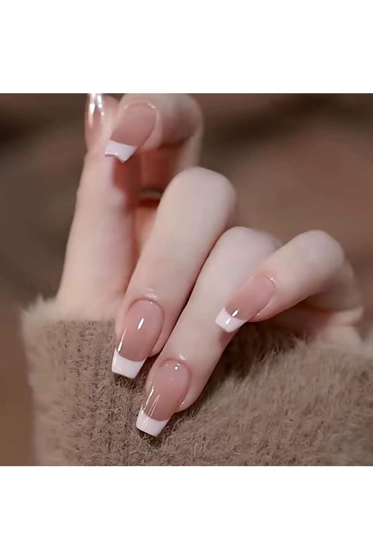 Sophisticated Elegant French Tip Manicure with Nude Base and Crisp White Tips.