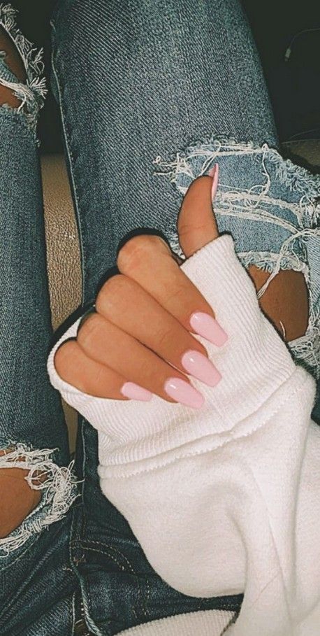 Chic and Relaxed: Stylish Long Nails with Soft Pink Polish Pair Perfectly with Cozy Sweater and Distressed Denim.