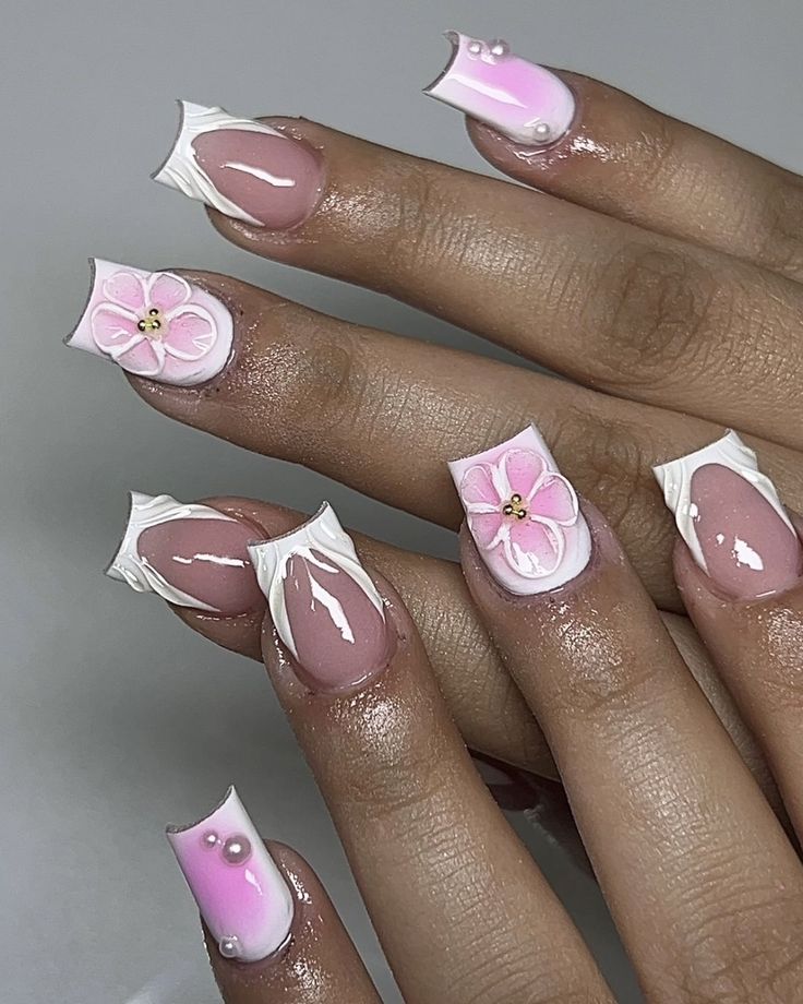 Elegant Pink and White Nail Art with Floral Accents and Playful Embellishments