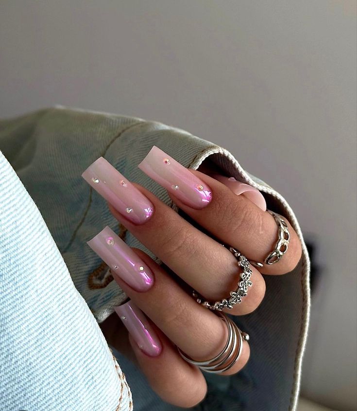 Chic Ombre Nail Design: Soft Pink to Magenta with Sparkling Gems and Minimalist Rings.