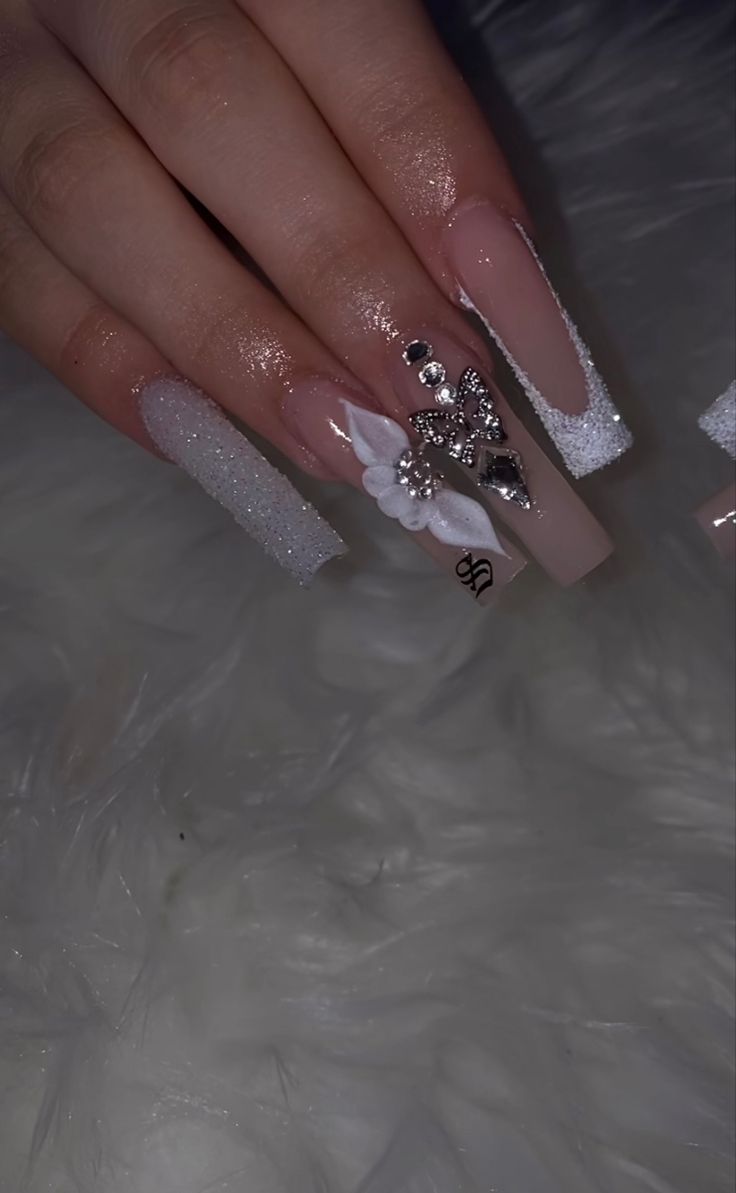 Chic Pastel Pink and Shimmering White Nail Design with Floral Embellishments and Rhinestones