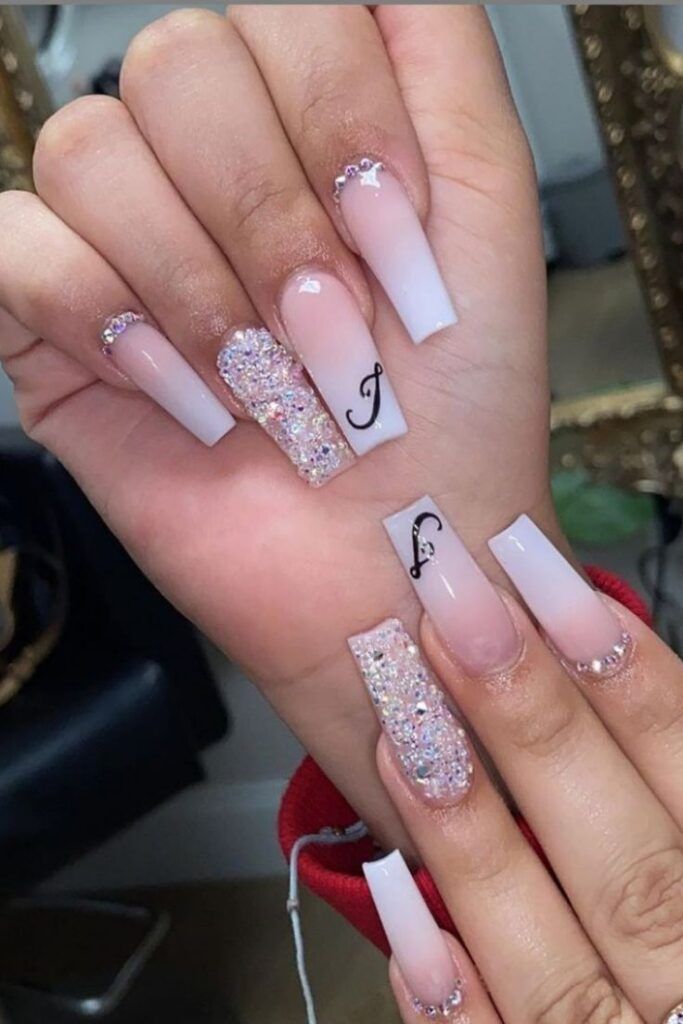 Chic Ombre Nail Design with Elegant Shades, Glitter, and Whimsical Accents.