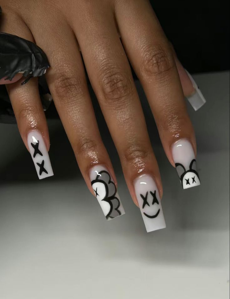 Chic Nail Design: Playful Patterns with Glossy Black Motifs on Nude Background.