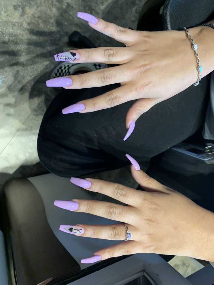 Trendy Lavender Acrylic Nails with Unique Designs and Elegant Jewelry.