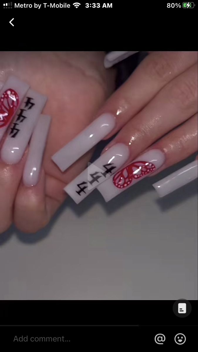 Modern Nail Design with Glossy Pale Background, Red and White Accents, and Butterfly Motifs.