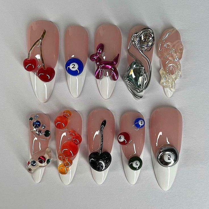 Artistic 3D Nail Designs with Whimsical Elements and Vibrant Contrast.