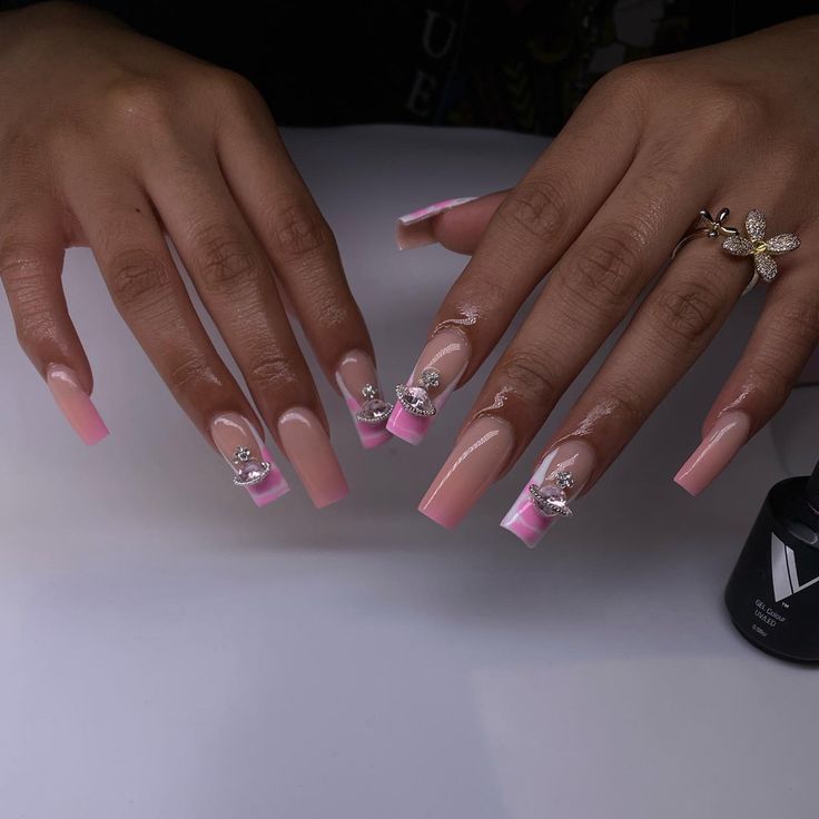 Glamorous Pink Ombre Nails with Rhinestones and Chic Tapered Design.