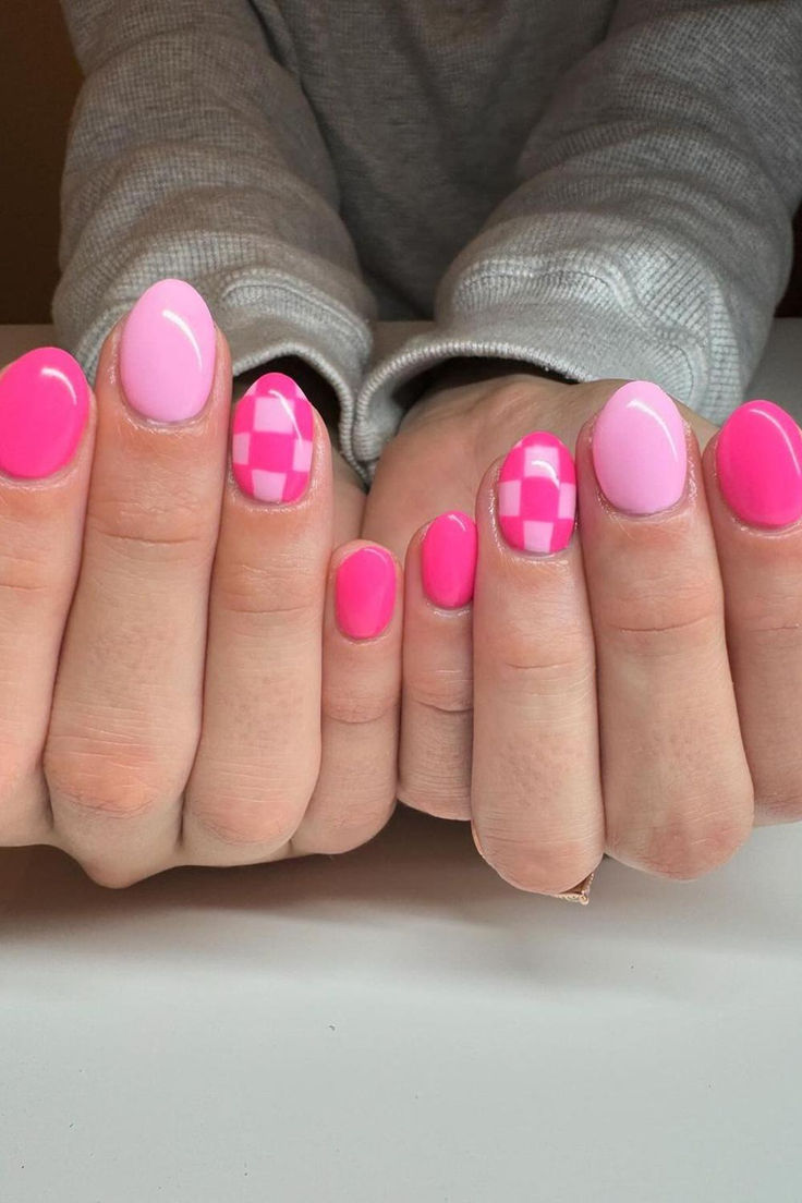 Vibrant Nail Art: Bold Pink and Pastel Designs with Checkered Patterns.