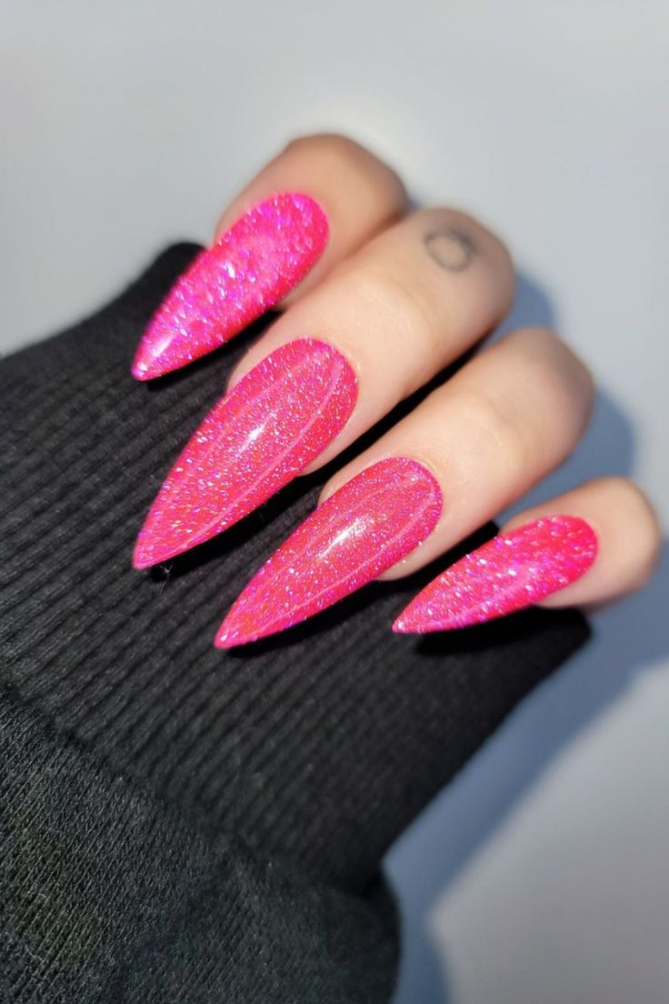 Bold Pink Stiletto Nails with Shimmering Glitter Finish for Eye-Catching Glam.