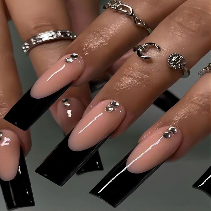 Chic Black-Tipped Nail Design with Nude Base and Glamorous Rhinestones.