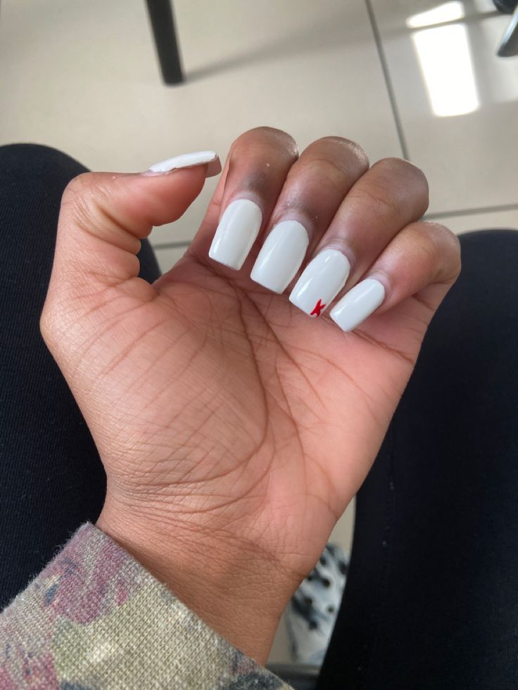 Elegant White Nails with Bold Red Accent Design.