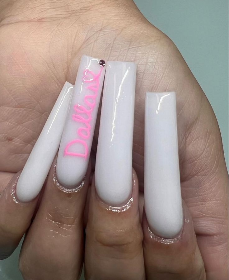 Chic Nude Nails with Playful Pink Inscription: A Perfect Blend of Elegance and Fun.