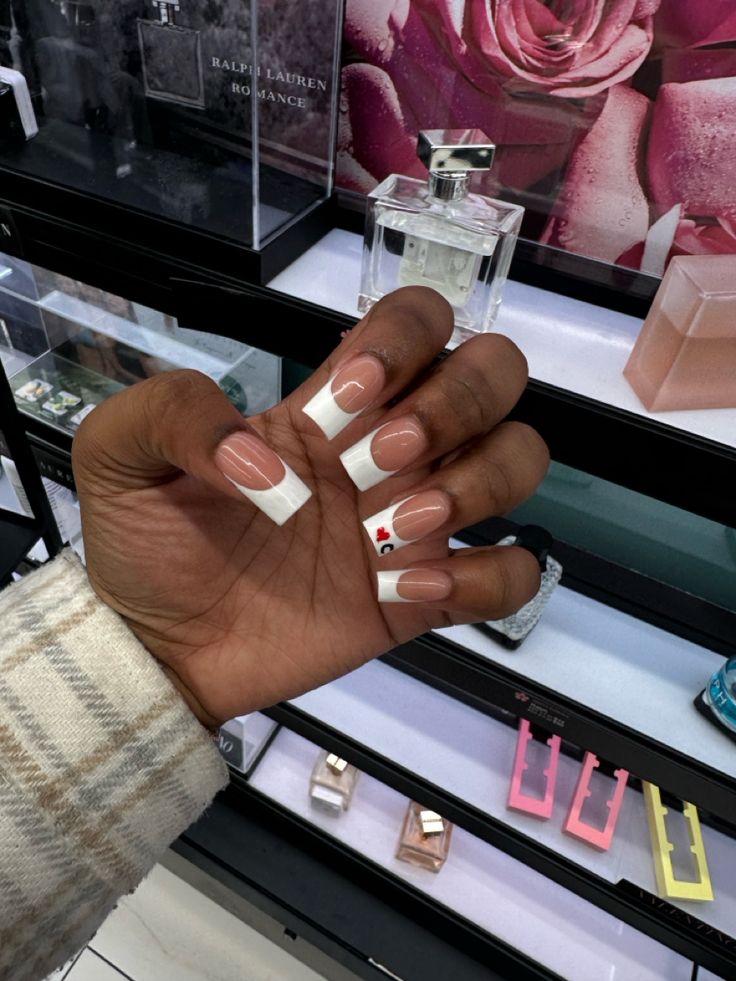 Chic French Tip Manicure with Nude, White, and Playful Cherry Accent