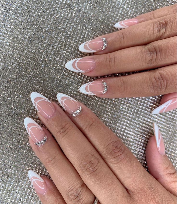 Sophisticated Elegant Nail Design with Soft Pink, French Tips, White Swirls, and Rhinestone Accents.