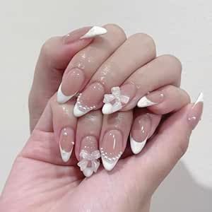 Elegant French-Tip Nails with Floral Embellishments and Playful Bows.