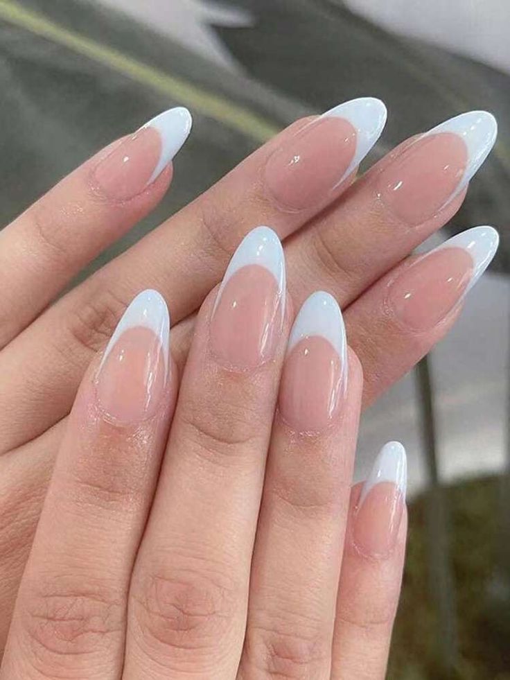 Chic Almond-Shaped Nail Design: Soft Blue Tips on a Natural Nude Base