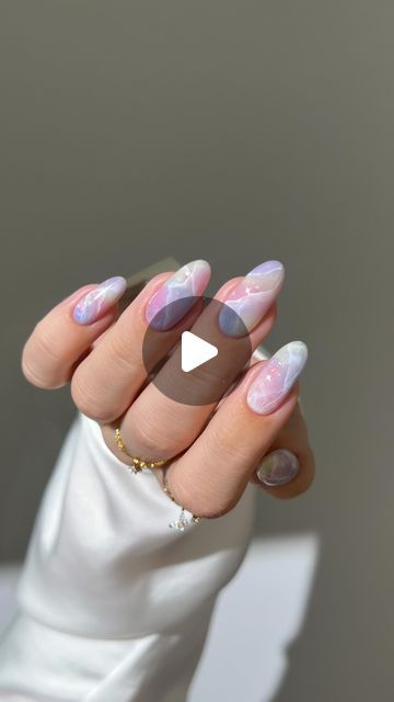 Dreamy Pastel Ombre Nail Design with Glossy Finishes and Artistic Marble Patterns