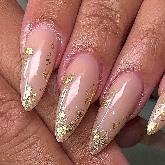 Sophisticated Almond-Shaped Nails with Soft Nude Base and Luxurious Gold Foil Accents.